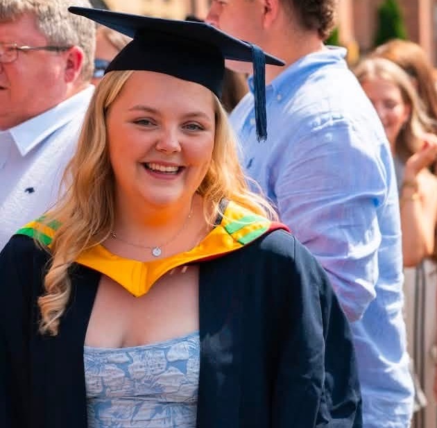 graduate smiling at camera